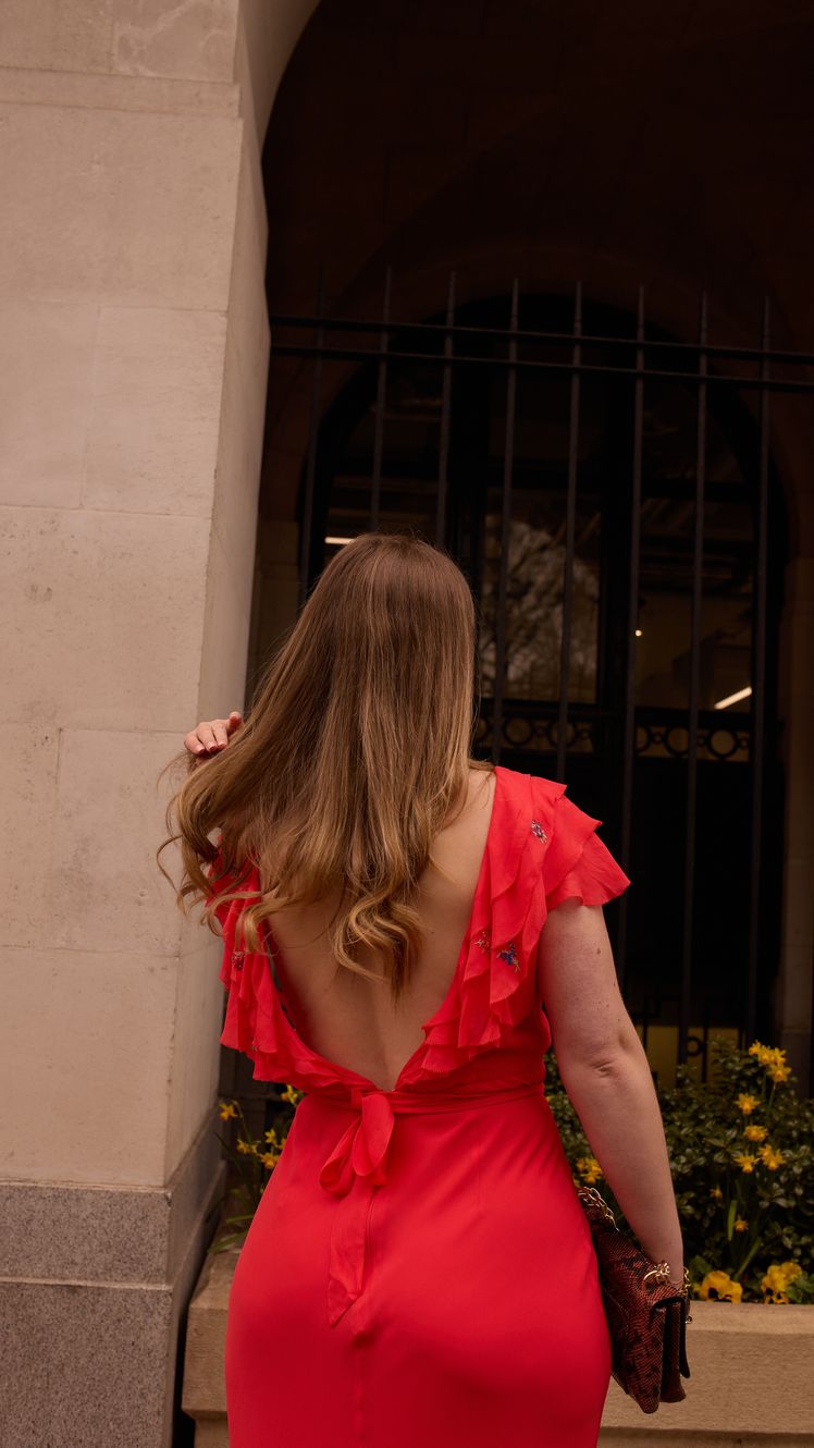 Image may contain Clothing Dress Evening Dress Formal Wear Blouse Adult Person Accessories Bag Handbag and Face