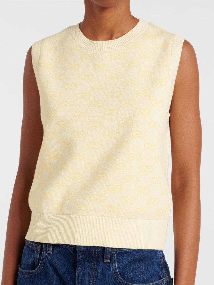 Image may contain Blouse Clothing Vest Tank Top Jeans Pants and Undershirt