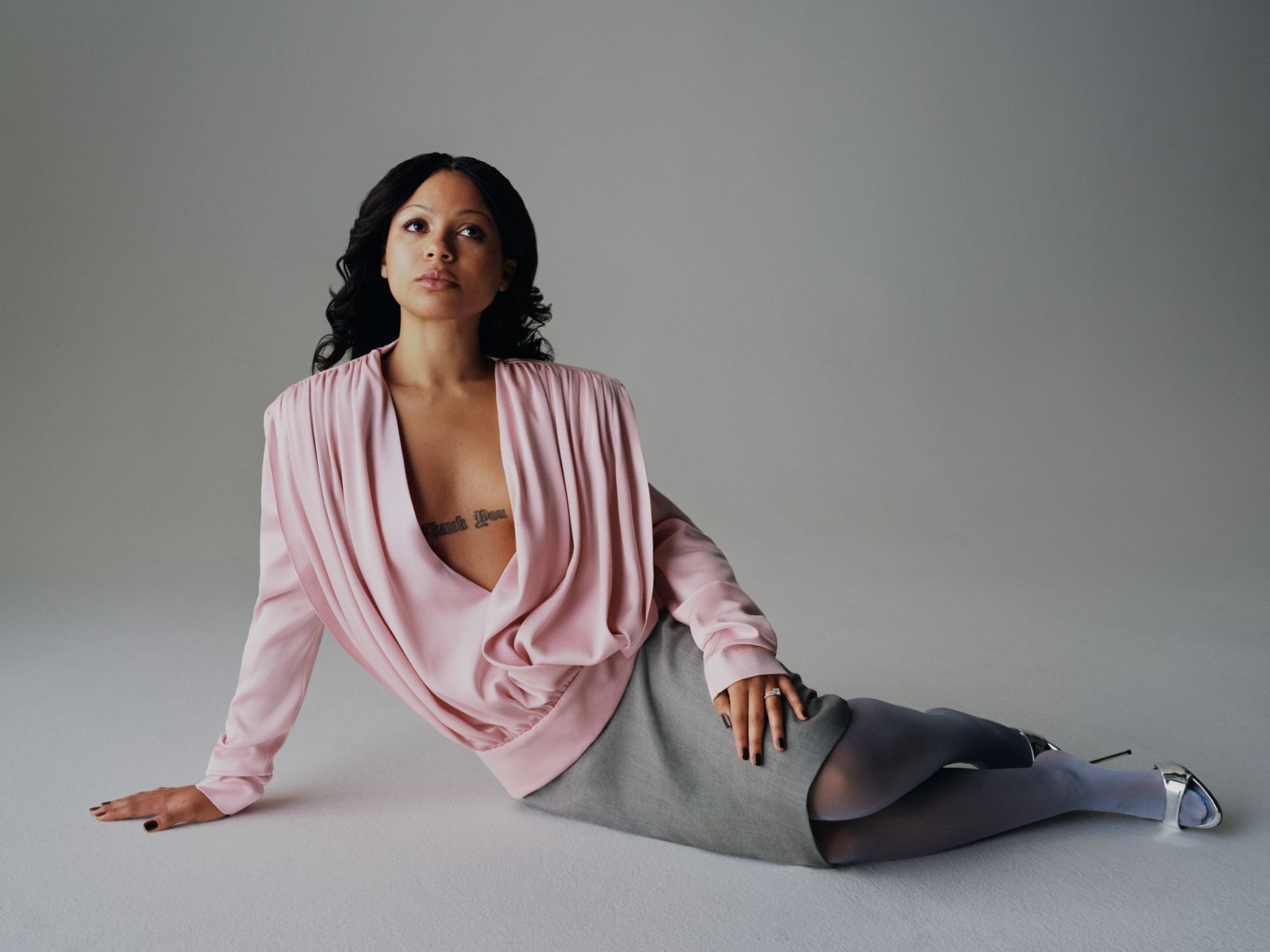 Image may contain Thishiwe Ziqubu Blouse Clothing Adult Person Long Sleeve Sleeve and Sitting