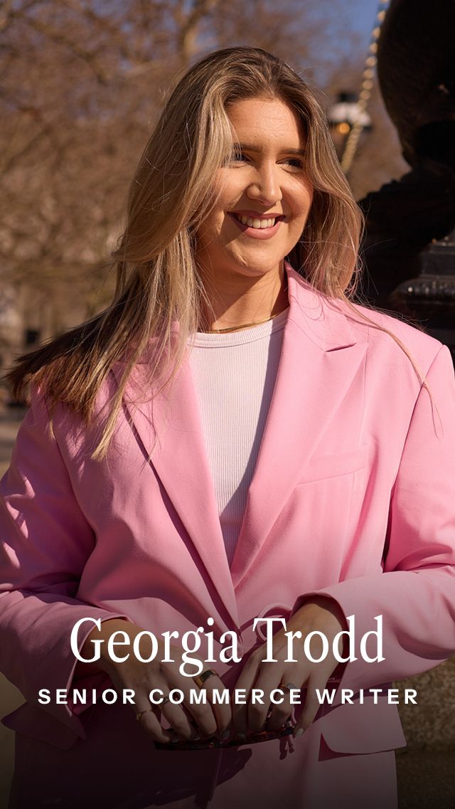 Image may contain Clothing Coat Jacket Blazer Face Head Person Photography Portrait Adult Formal Wear and Happy