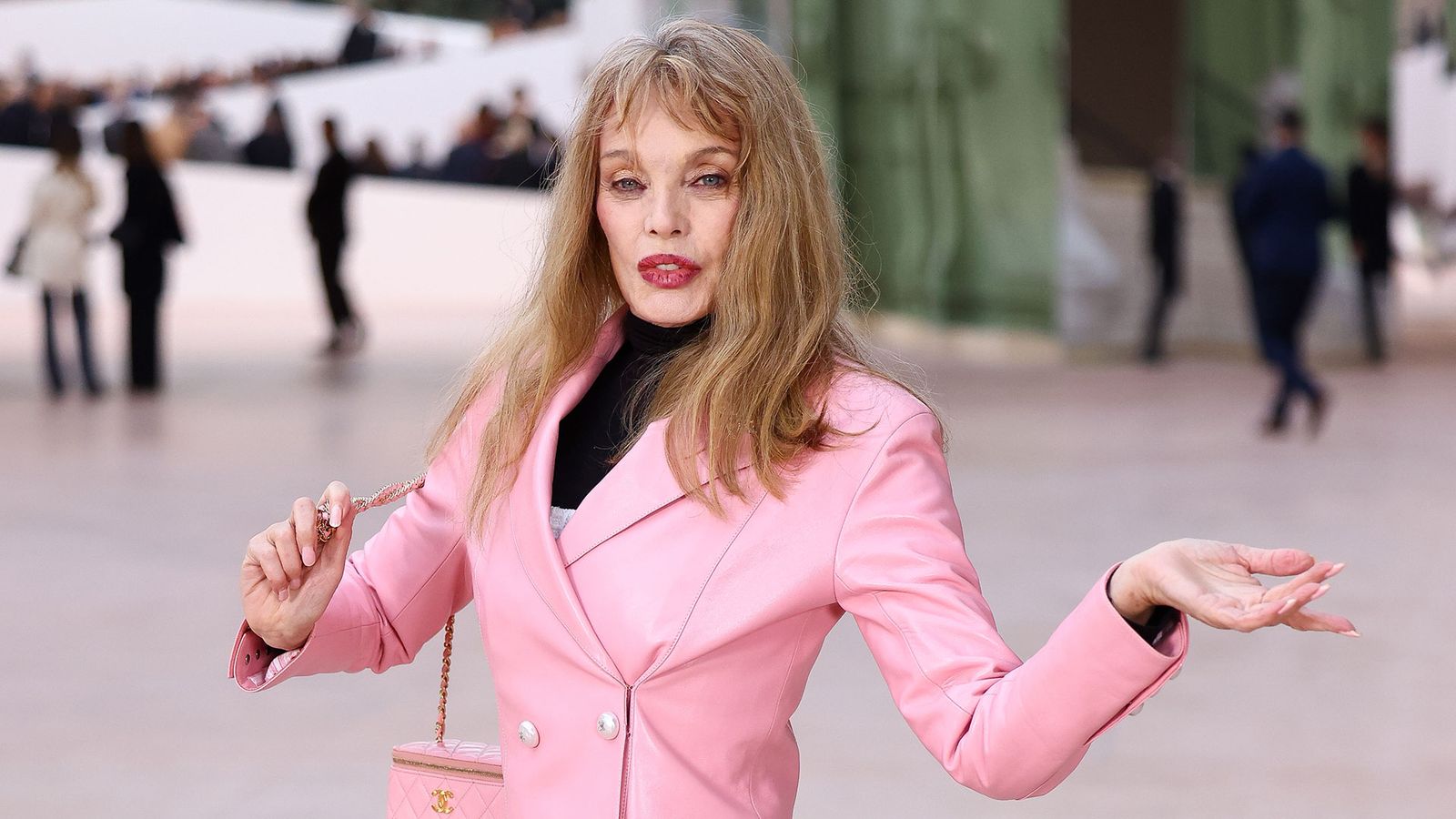 Image may contain Arielle Dombasle Blonde Hair Person Clothing Coat Formal Wear Head Face Adult Jacket and Suit