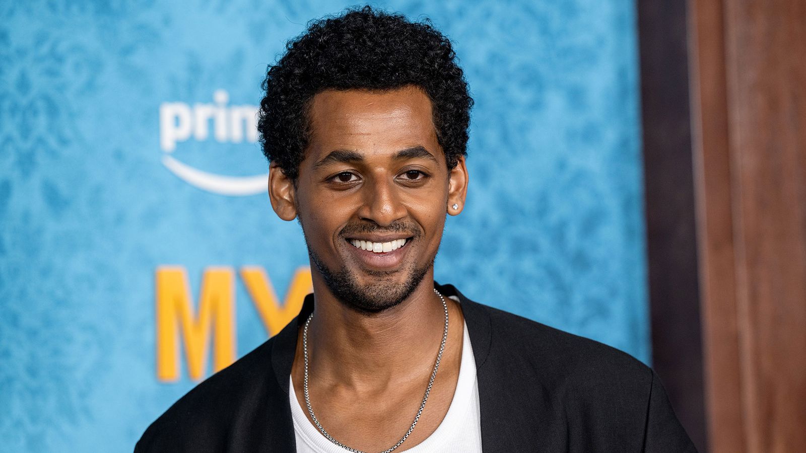 Image may contain Body Part Face Head Neck Person Dimples Adult Accessories Jewelry and Necklace