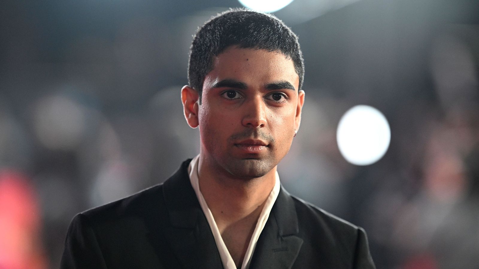 Image may contain Body Part Face Head Neck Person Photography Portrait Adult Clothing Coat Crew Cut and Hair